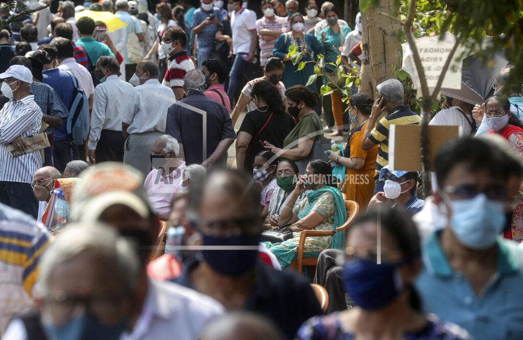 Rafiq Maqbool FILE - In this April 26, 2021, file photo, people queue up for COVID-19 vaccine in Mumbai, India. Developing Asian economies will grow at a solid 7.3% pace this year after contracting slightly in 2020 due to the pandemic, the Asian Development Bank says in its latest regional outlook. (AP Photo/Rafiq Maqbool, File)