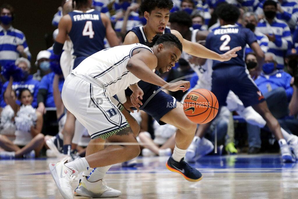 Chris Seward Duke guard Trevor Keels (1) and Virginia guard Kihei Clark (0) keep their eyes on a loose ball during the first half of an NCAA college basketball game, Monday, Feb. 7, 2022, in Durham, N.C. (AP Photo/Chris Seward)