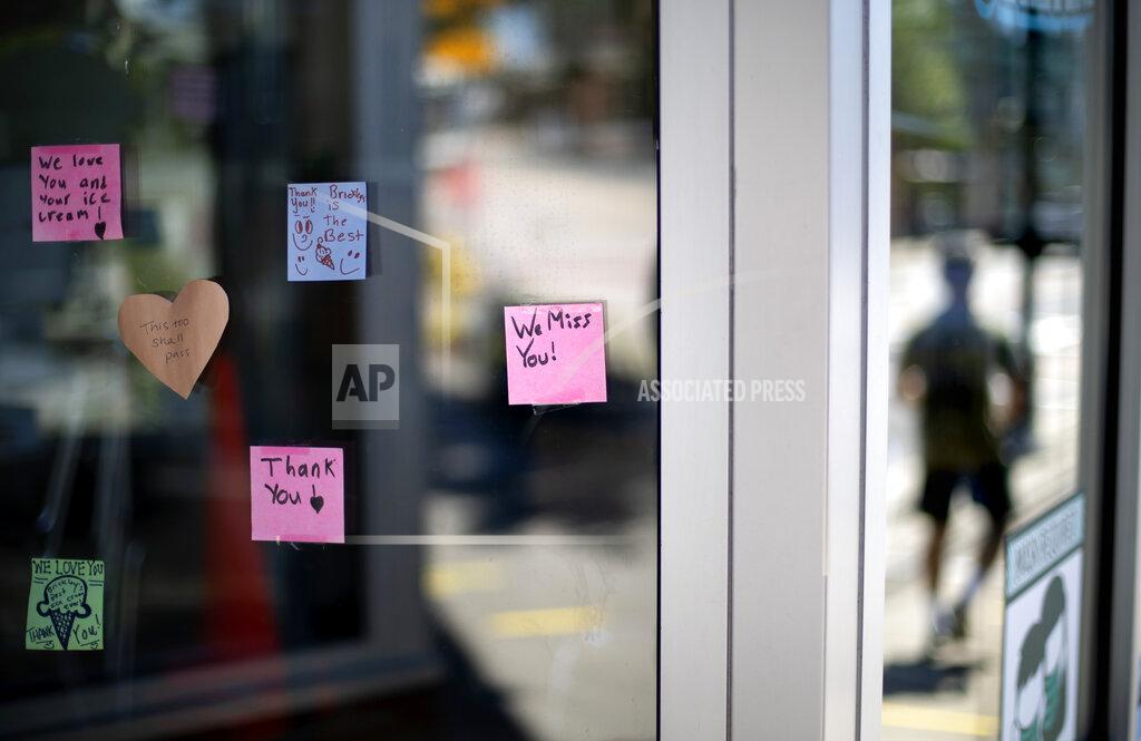 David Goldman Notes from customers are posted on the window of one of two Brickley's Ice Cream shops which closed for the season after teenage workers were harassed by customers who refused to wear a mask or socially distance, in Wakefield, R.I., Wednesday, July 29, 2020. Disputes over masks and mask mandates are playing out at businesses, on public transportation and in public places across America and other nations. (AP Photo/David Goldman)