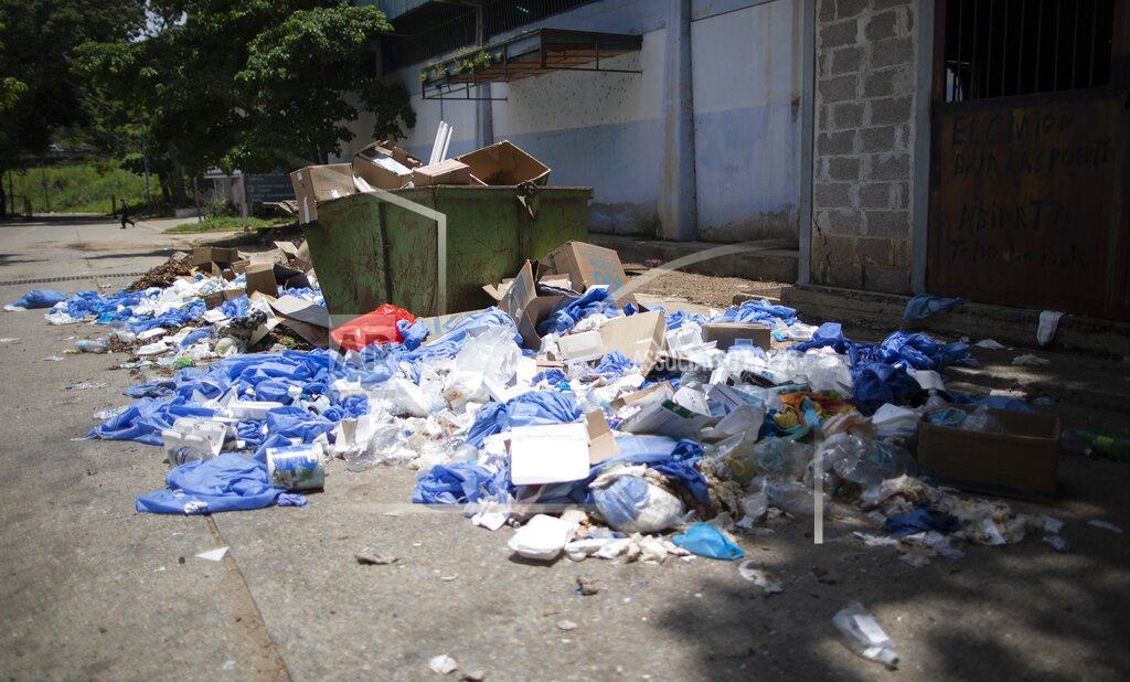 Ariana Cubillos Garbage lays outside the José Gregorio Hernández Hospital, a public hospital in the Catia neighborhood of Caracas, Venezuela, Thursday, Sept. 24, 2020, with the red bag containing what's considered the most contaminated. Venezuela’s decline has left its mark on the public hospital, a 47-year-old, nine-story building of exposed concrete, where just a couple hundred beds remain in use. (AP Photo/Ariana Cubillos)