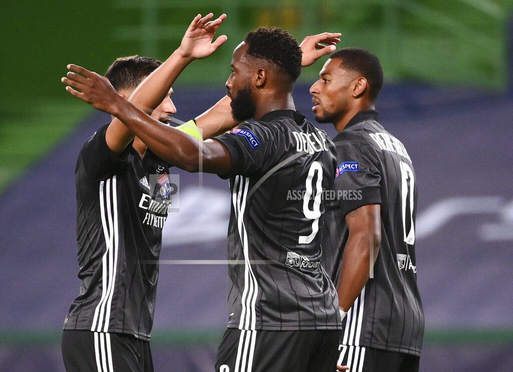 Franck Fife Lyon's Moussa Dembele, centre, celebrates with teammates after scoring his team's third goal during the Champions League quarterfinal match between Manchester City and Lyon at the Jose Alvalade stadium in Lisbon, Portugal, Saturday, Aug. 15, 2020. (Franck Fife/Pool Photo via AP)