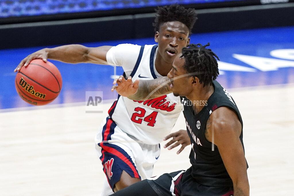 Mark Humphrey Mississippi's Jarkel Joiner (24) drives against South Carolina's T.J. Moss, right, in the first half of an NCAA college basketball game in the Southeastern Conference Tournament Thursday, March 11, 2021, in Nashville, Tenn. (AP Photo/Mark Humphrey)
