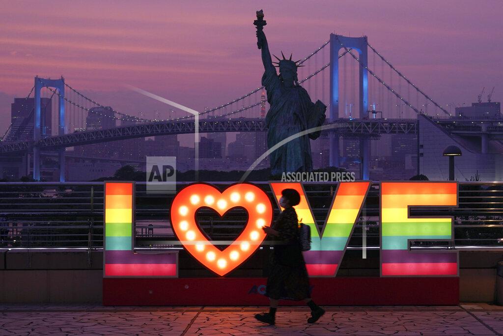 Eugene Hoshiko A visitor walks at Odaiba at sunset Wednesday, June 3, 2020, in Tokyo. A coronavirus state of emergency has been lifted, ending the restrictions nationwide as businesses began to reopen.(AP Photo/Eugene Hoshiko)