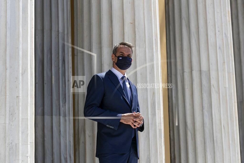 Yorgos Karahalis Greece's Prime Minister Kyriakos Mitsotakis waits to welcome the leaders of Cyprus and Jordan ahead of a meeting, in Athens, on Wednesday, July 28, 2021. Greece is hosting a one-day trilateral meeting of the three leaders. (AP Photo/Yorgos Karahalis)