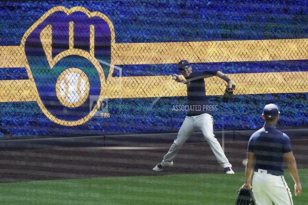Morry Gash Milwaukee Brewers' Christian Yelich throws during a practice session Monday, July 13, 2020, at Miller Park in Milwaukee. (AP Photo/Morry Gash)