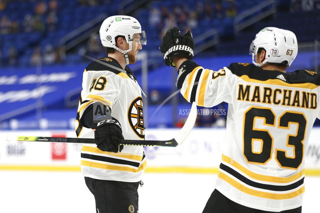 Jeffrey T. Barnes Boston Bruins forward Matt Grzelcyk (48) celebrates his goal with forward Brad Marchand (63) during the second period of the team's NHL hockey game against the Buffalo Sabres, Thursday, April 22, 2021, in Buffalo, N.Y. (AP Photo/Jeffrey T. Barnes)