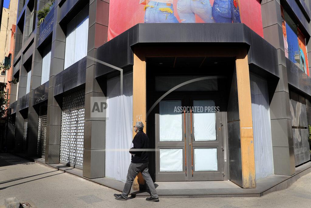 Hussein Malla A man passes next of one of bigger clothes shop that close for ever after the economy crisis on Beirut's commercial Hamra Street, in Beirut, Lebanon, Tuesday, March 16, 2021. (AP Photo/Hussein Malla)