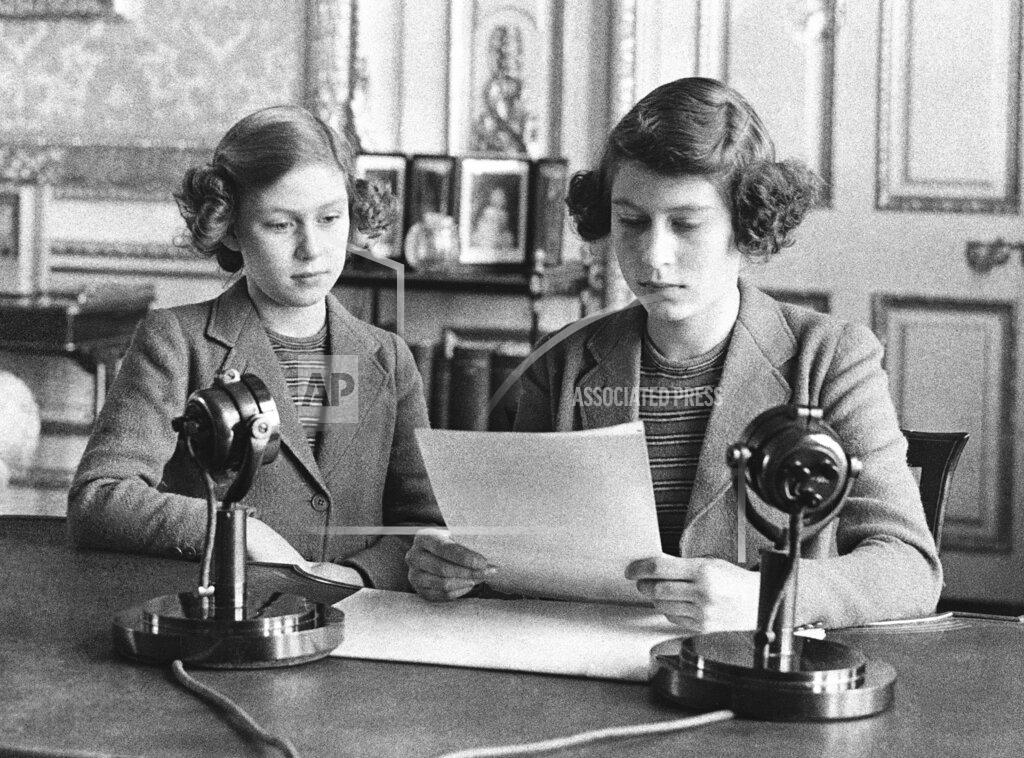 Uncredited FILE - Princess Elizabeth, 14, right, appears with her sister Princess Margaret before giving her first radio broadcast in London on Oct. 13, 1940. (AP Photo, File)
