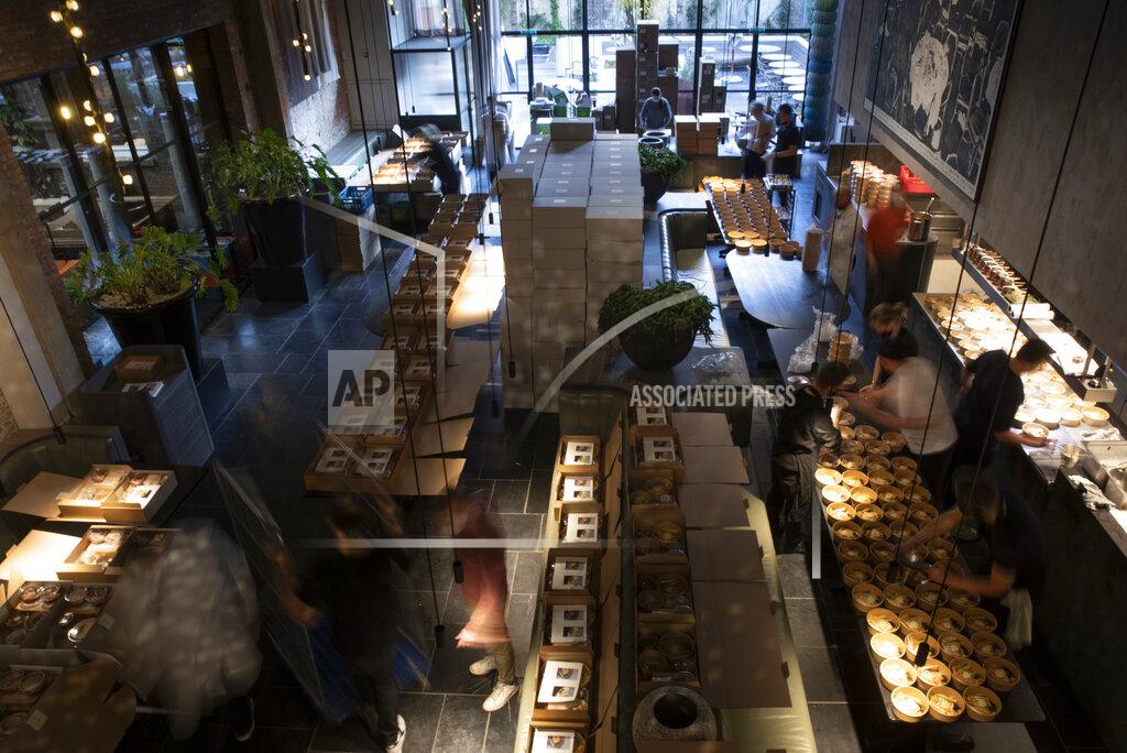 Virginia Mayo Staff prepare part of nearly 600 take-away orders at Sergio Herman's Le Pristine restaurant in Antwerp, Belgium, Saturday, Nov. 7, 2020. Of all the many challenges the pandemic throws up for all kinds of professions, this one has been particularly tough: How to put a three-star chef into a takeout box. (AP Photo/Virginia Mayo)
