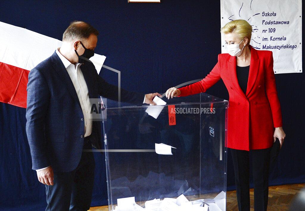 Czarek Sokolowski Candidate in Poland's tight presidential election runoff, incumbent President Andrzej Duda and First Lady Agata Kornhauser-Duda cast their ballots at a polling station in their hometown of Krakow, Poland, on Sunday, July 12, 2020. Conservative Duda is running against liberal Warsaw Mayor Rafal Trzaskowski and latest opinion polls suggest the race will be decided by a very narrow margin.(AP Photo/Czarek Sokolowski)