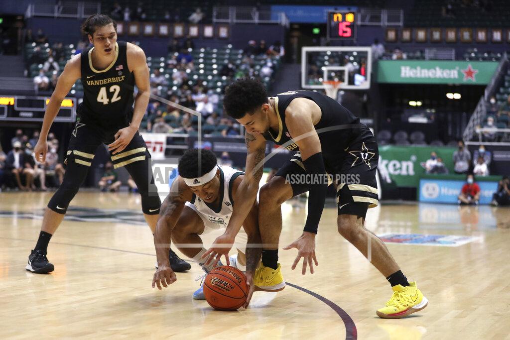 Marco Garcia Hawaii guard JoVon McClanahan (3) and Vanderbilt guard Scotty Pippen Jr. (2) fight for a loose ball in the second half of an NCAA college basketball game Wednesday, Dec. 22, 2021, in Honolulu. (AP Photo/Marco Garcia)