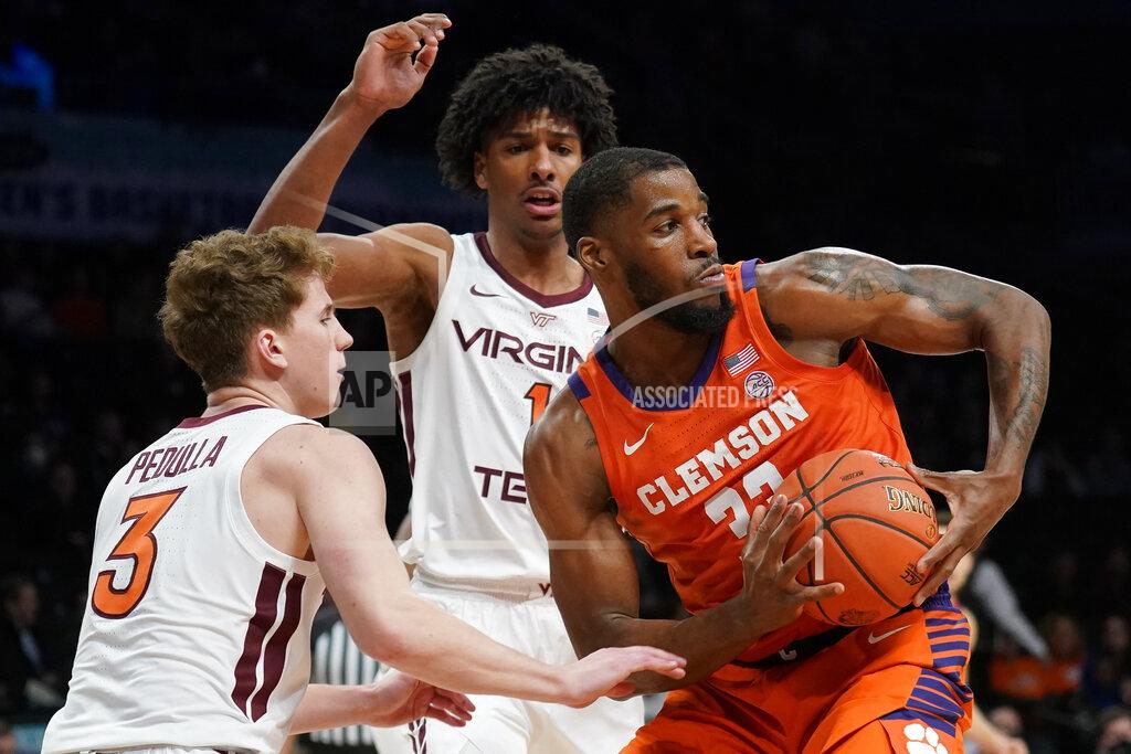 John Minchillo Clemson Tigers' Naz Bohannon (33) looks to pass against Virginia Tech's Sean Pedulla (3) and David N'Guessan (1) in the first half of an NCAA college basketball game during the Atlantic Coast Conference men's tournament, Wednesday, March 9, 2022, in New York. (AP Photo/John Minchillo)