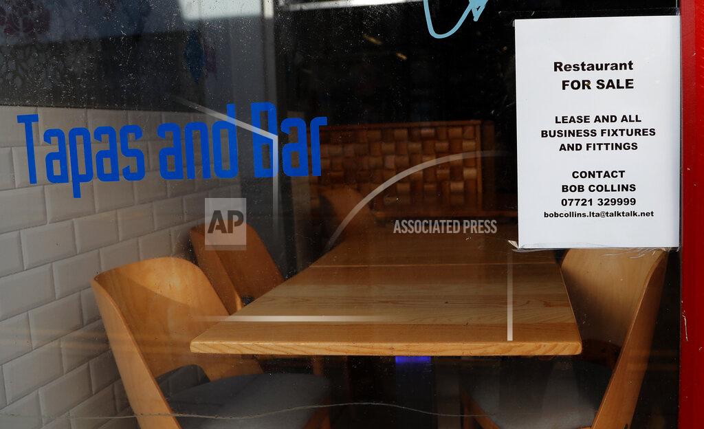 Frank Augstein A 'For Sale' sign is placed in the window of a former restaurant in Liverpool, England, Wednesday, Oct. 14, 2020. As the first area in England slapped with strict new restrictions to curb the resurgent coronavirus that have shuttered pubs and imperiled thousands of jobs, Liverpool again feels it's being punished by policies made in Britain's capital, 180 miles (290 kilometers) to the south. (AP Photo/Frank Augstein)
