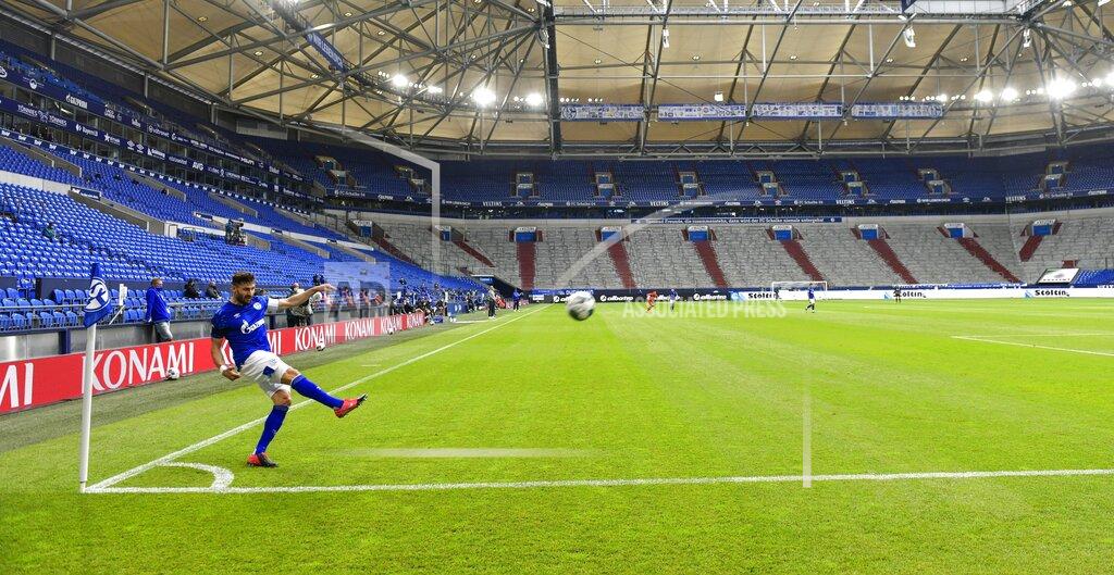 Martin Meissner FILE - In this May 24, 2020, file photo, Schalke's Daniel Caligiuri kicks the ball in front of empty seats during the German Bundesliga soccer match between FC Schalke 04 and FC Augsburg at the Veltins-Arena in Gelsenkirchen, Germany. (AP Photo/Martin Meissner, Pool, File)