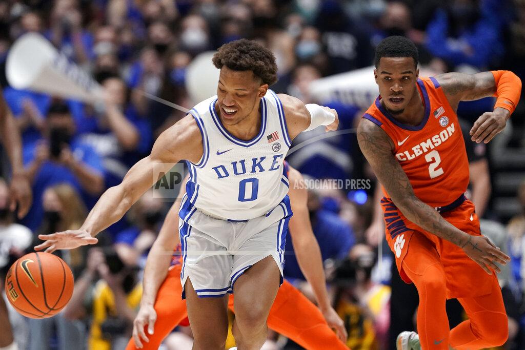 Gerry Broome Duke forward Wendell Moore Jr. (0) reaches for the ball while Clemson guard Al-Amir Dawes (2) chases during the first half of an NCAA college basketball game in Durham, N.C., Tuesday, Jan. 25, 2022. (AP Photo/Gerry Broome)