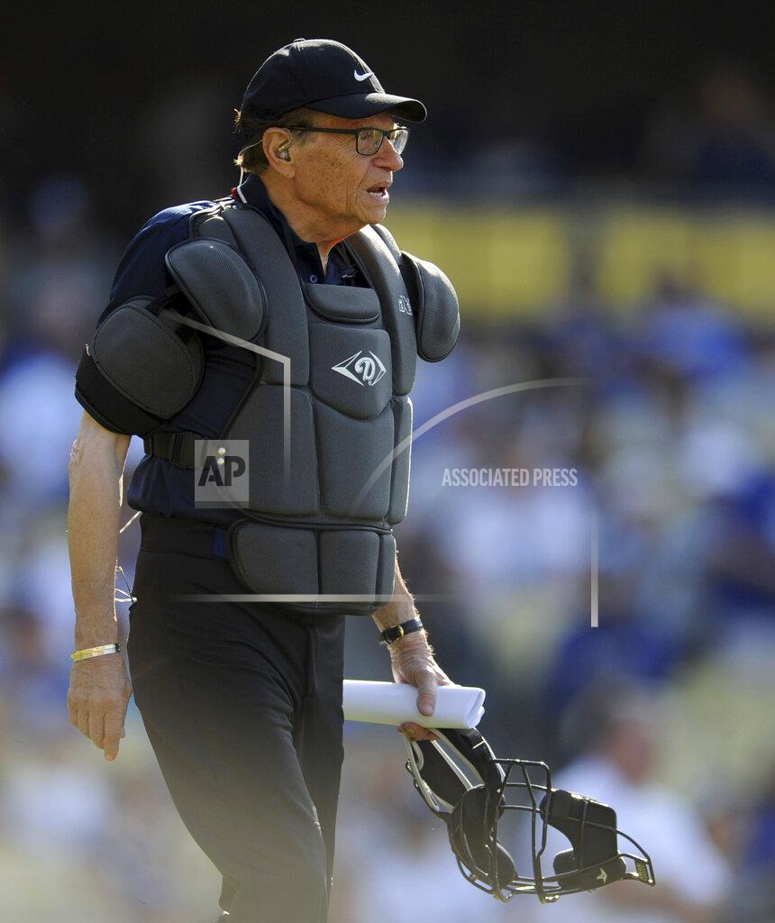 Keith Birmingham TV host Larry King works as the home plate umpire during the Old-Timers game prior to a baseball game between the Atlanta Braves and the Los Angeles Dodgers Saturday, June 8, 2013, in Los Angeles. King, the suspenders-sporting everyman whose broadcast interviews with world leaders, movie stars and ordinary Joes helped define American conversation for a half-century, died Saturday, Jan. 23, 2021, at age 87. (Keith Birmingham/The Orange County Register/SCNG via AP)