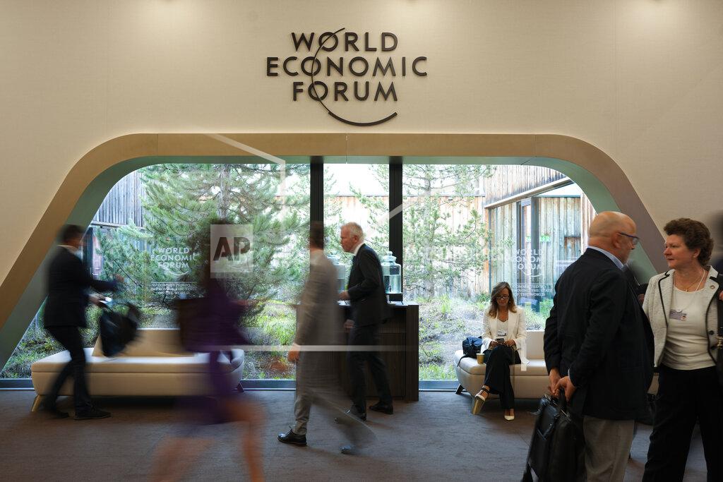 Markus Schreiber Participants walk through the Davos Congress Center, the venue of the annual meeting of the World Economic Forum in Davos, Switzerland, Monday, May. 23, 2022. The annual meeting of the World Economic Forum is taking place in Davos from May. 22 until May. 26, 2020. (AP Photo/Markus Schreiber)