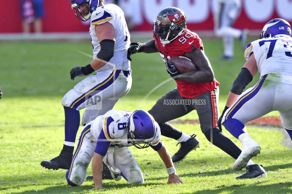Jason Behnken Tampa Bay Buccaneers outside linebacker Jason Pierre-Paul (90) runs with the ball after stripping it away from Minnesota Vikings quarterback Kirk Cousins (8) during the second half of an NFL football game Sunday, Dec. 13, 2020, in Tampa, Fla. (AP Photo/Jason Behnken)