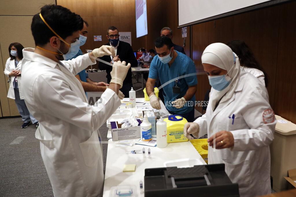 Bilal Hussein Medical works prepare the syringes of the Pfizer-BioNTech COVID-19 vaccine during a nationwide vaccination program at the American University Medical Center in Beirut, Lebanon, Sunday, Feb. 14, 2021. (AP Photo / Bilal Hussein)