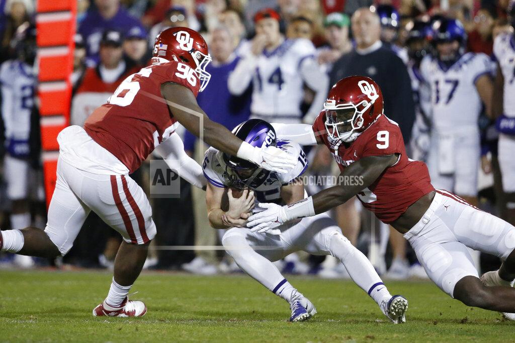 Sue Ogrocki Oklahoma defensive lineman LaRon Stokes (96) and Kenneth Murray (9) sack TCU quarterback Max Duggan (15) in the first half of an NCAA college football game in Norman, Okla., Saturday, Nov. 23, 2019. (AP Photo/Sue Ogrocki)