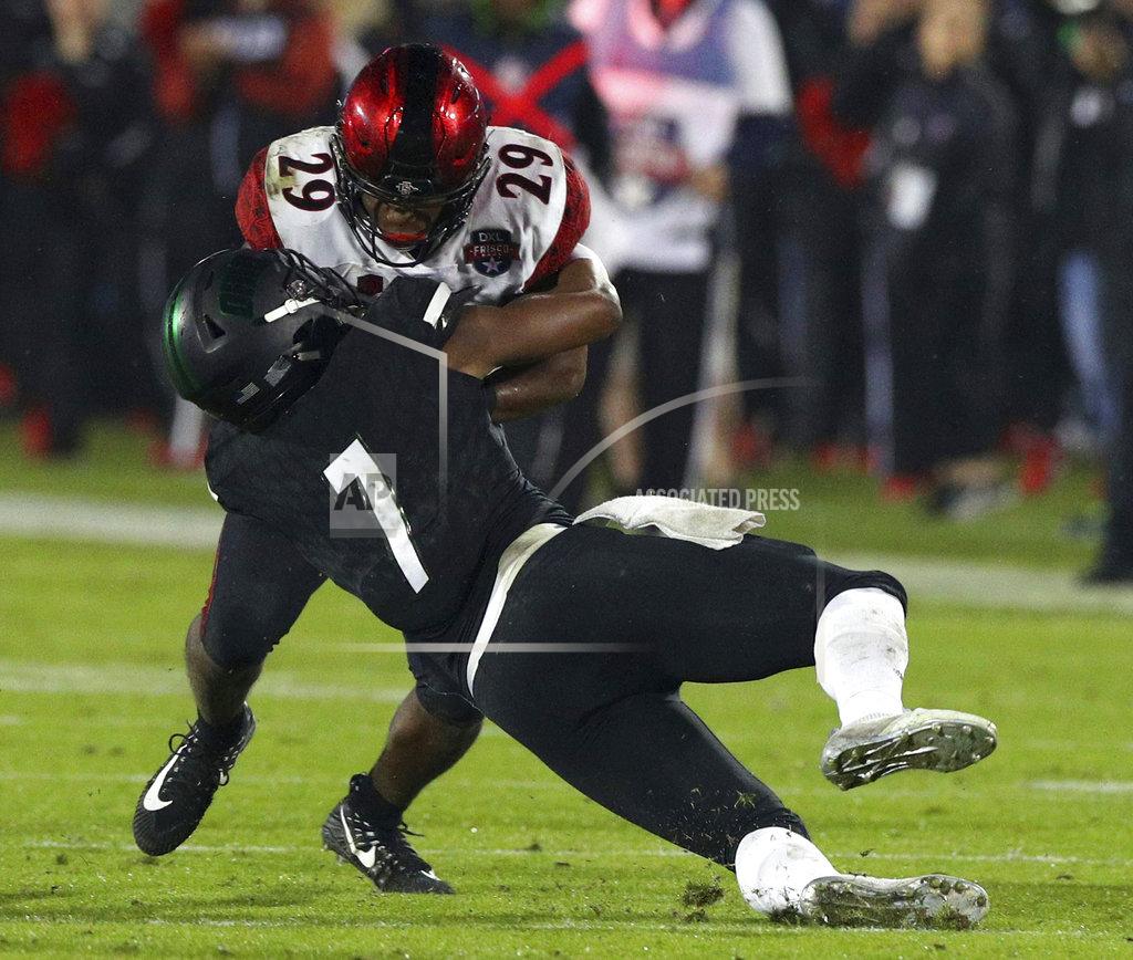 Richard W. Rodriguez San Diego State running back Juwan Washington (29) gets tackled by Ohio safety Javon Hagan (7) in the second half of the Frisco Bowl NCAA college football game, Wednesday, Dec. 19, 2018, in Frisco, Texas. (AP Photo/Richard W. Rodriguez)