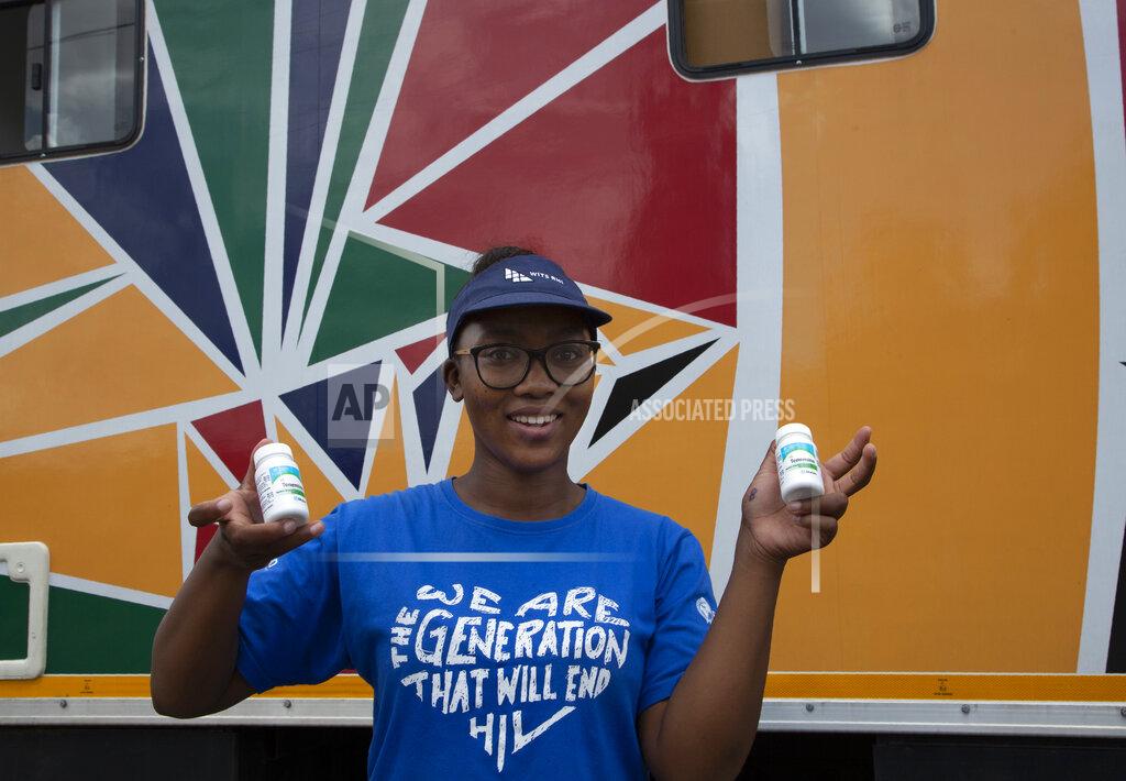 Denis Farrell Khanyiswa Kwatsha, who runs a mobile clinic for the Reproductive Health and HIV Institute (RHI) background, shows containers of PrEP medication used in the prevention of HIV infectionin in the Soshanguve Township, north of Pretoria, South Africa, Thursday, Nov. 26 2020. The successful trials of a new injectable drug that needs to be taken every eight weeks to prevent HIV infection is being lauded on World AIDS Day as a turning point for the fight against a global health threat that's been eclipsed by the coronavirus pandemic. (AP Photo/Denis Farrell)