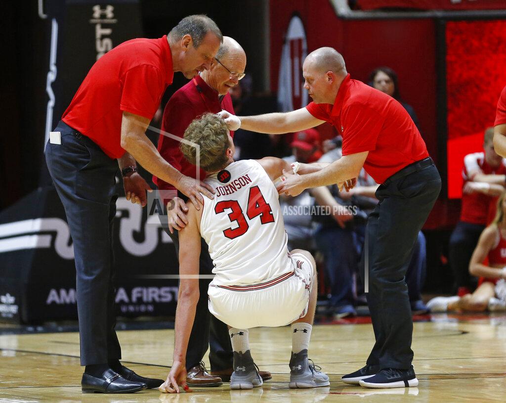 Rick Bowmer Utah center Jayce Johnson (34) is helped to his feet during the second half of the team's NCAA college basketball game against Washington on Thursday, Jan., 10, 2019, in Salt Lake City. (AP Photo/Rick Bowmer)