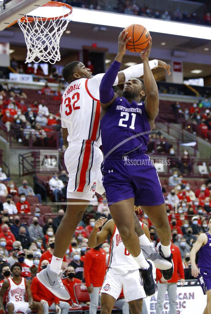 Paul Vernon Northwestern forward Elyjah Williams, right, goes up to shoot in front of Ohio State forward E.J. Liddell during the first half of an NCAA college basketball game in Columbus, Ohio, Sunday, Jan. 9, 2022. (AP Photo/Paul Vernon)