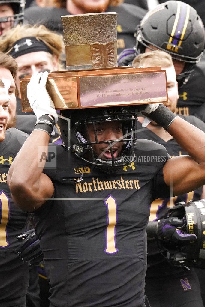 Nam Y. Huh Northwestern running back Jesse Brown (1) celebrates with teammates as he holds the Land of Lincoln Trophy after Northwestern defeated Illinois 28-10 in an NCAA college football game in Evanston, Ill., Saturday, Dec. 12, 2020. (AP Photo/Nam Y. Huh)