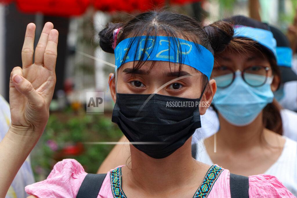 Uncredited An anti-coup protester flashes the three-fingered salute while wearing a headband that reads R2P, which means Responsibility to Protect, during a gathering in Ahlone township in Yangon, Myanmar Monday, April 12, 2021. The protesters have called for foreign intervention to aid them under the doctrine of Responsibility to Protect, or R2P, devised to deal with matters such as genocide, war crimes, ethnic cleansing and crimes against humanity. (AP Photo)
