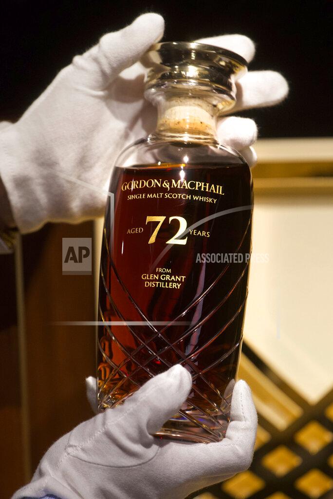 Vincent Yu Expecting to fetch up to US$49,000 at auction, a 72-year-old bottle of Glen Grant single malt whisky from Scotland is displayed at a Bonhams auction preview in Hong Kong, Thursday, Jan. 28, 2021. Despite the economic uncertainty brought on by the pandemic, interest in the rare whisky remains high. Compared to other investment commodities, collectable whisky is doing strong in the past 10 years, with a four-fold increase in its price, Bonhams specialist Christopher Pong said. (AP Photo/Vincent Yu)