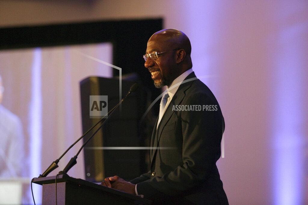 Akili-Casundria Ramsess Sen. Raphael Warnock, D-Ga., addresses the Gwinnett County Democratic Party fundraiser on Saturday, May 21, 2022 in Norcross, Ga. (AP Photo/Akili-Casundria Ramsess)