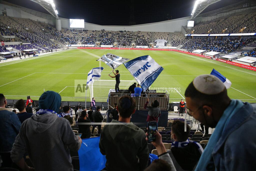 Ariel Schalit Israeli fans cheer before the World Cup 2022 group F qualifying soccer match between Israel and Denmark in Tel Aviv, Israel, Thursday, March 25, 2021. (AP Photo/Ariel Schalit)