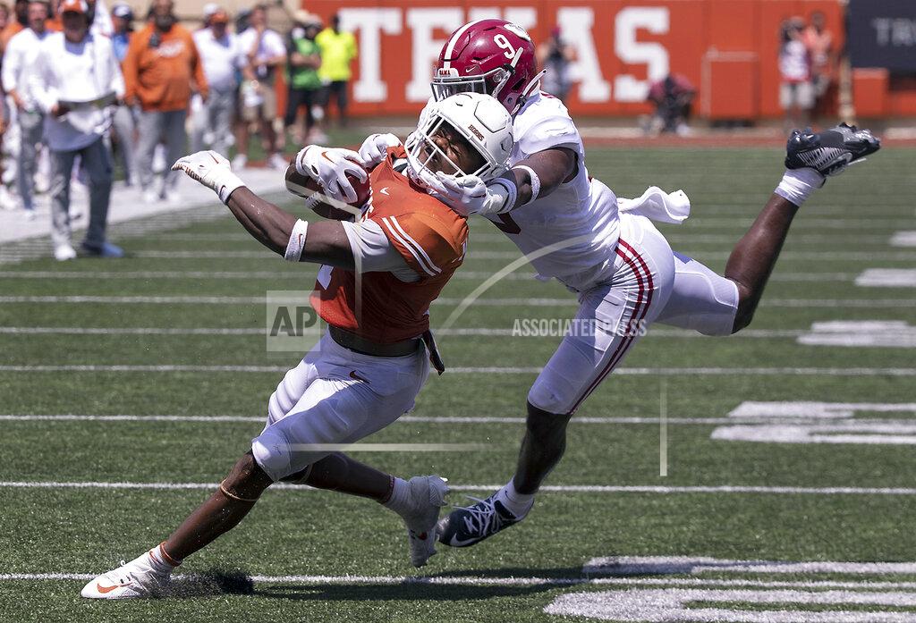 Rodolfo Gonzalez Texas running back Keilan Robinson (7) has his face mask grabbed by Alabama defensive back Jordan Battle (9) during the second half of an NCAA college football game, Saturday, Sept. 10, 2022, in Austin, Texas. Alabama defeated Texas 20-19. (AP Photo/Rodolfo Gonzalez)