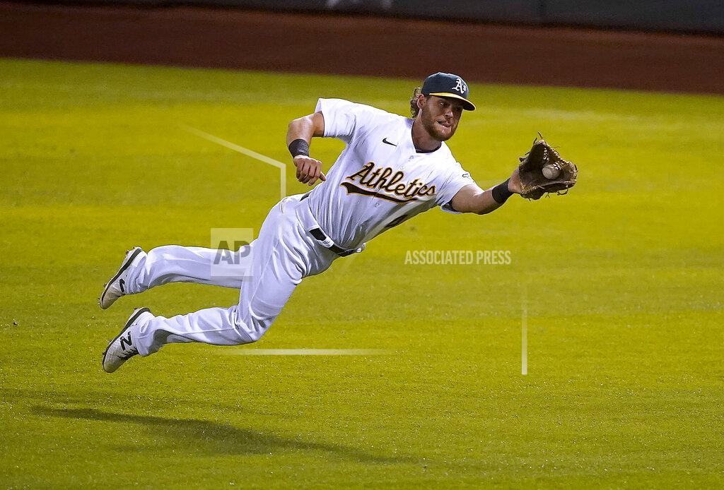 Tony Avelar Oakland Athletics right fielder Chad Pinder makes a diving catch on a hit by Houston Astros' Jose Altuve during the fifth inning of an opening day baseball game in Oakland, Calif., Thursday, April 1, 2021. (AP Photo/Tony Avelar)