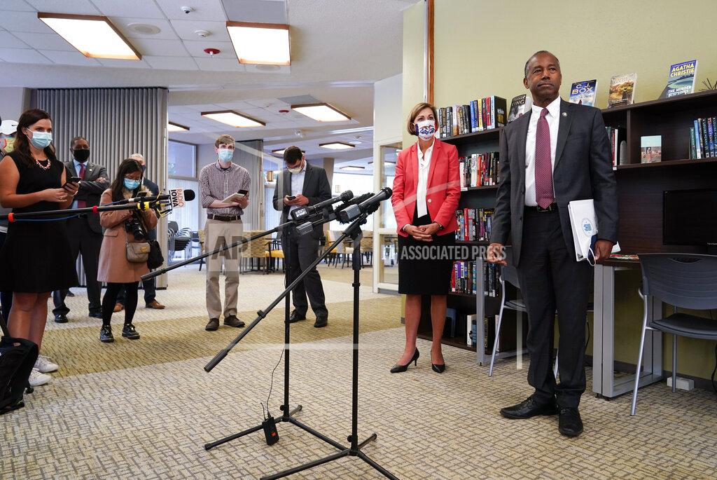 Housing and Urban Development Secretary Ben Carson and Iowa Gov. Kim Reynolds speak to reporters after touring the Plymouth Place senior housing facility, Tuesday, Sept. 22, 2020, in Des Moines, Iowa. (AP Photo/Charlie Neibergall)