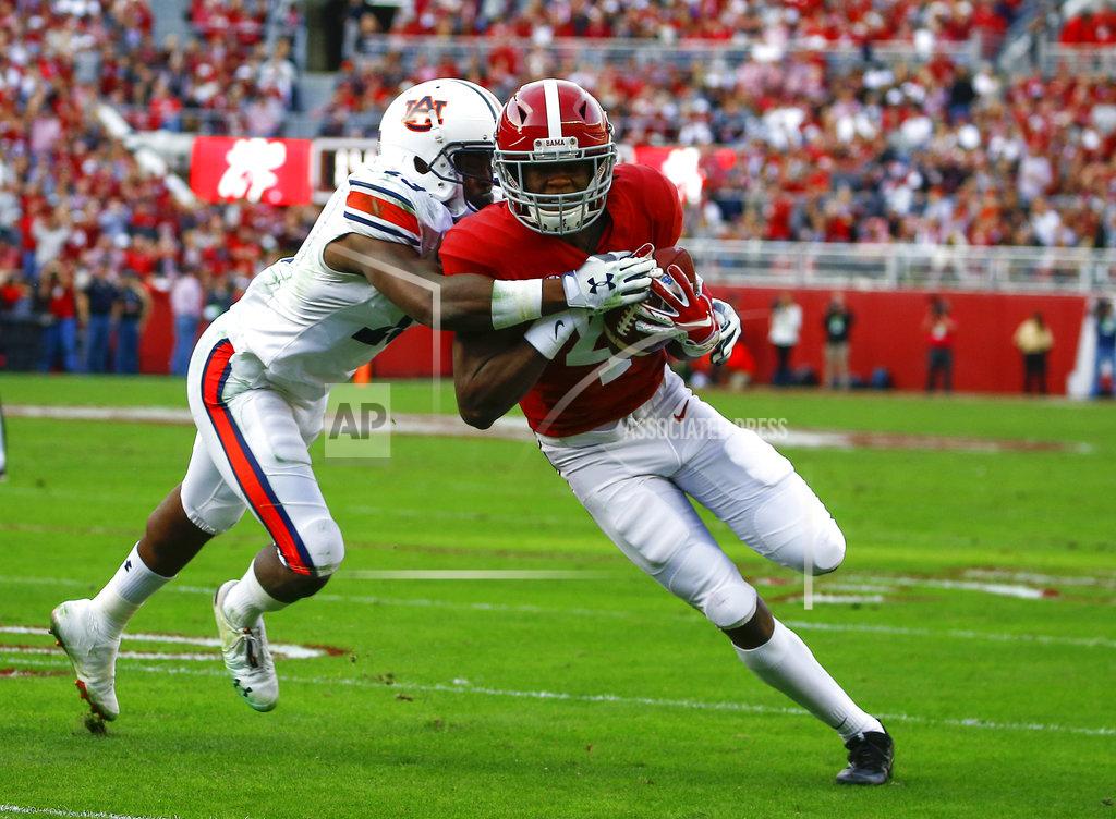 Butch Dill FILE - In this Nov. 24, 2018, file photo, Alabama wide receiver Jerry Jeudy (4) is tackled by Auburn defensive back Javaris Davis (13) after a reception during the first half of an NCAA college football game, in Tuscaloosa, Ala. Jeudy’s ambitions grew with every college football camp he attended, every highly rated defensive back he beat head to head. His recruiting stock rose, and so did his goals. Now, he’s Alabama’s latest star wide receiver and a Biletnikoff Award winner heading into the College Football Playoffs. (AP Photo/Butch Dill, File)
