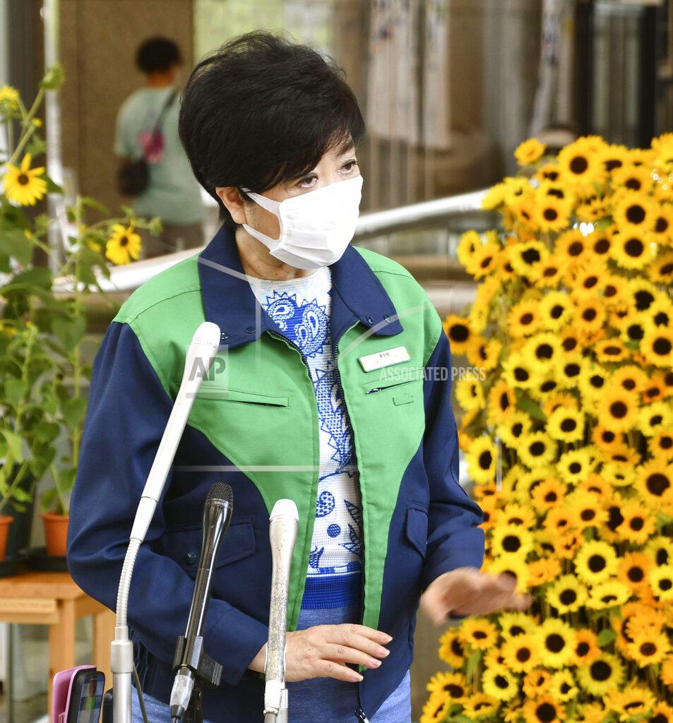 Uncredited Tokyo Gov. Yuriko Koike speaks during a news conference at Tokyo Metropolitan Government Office in Tokyo Wednesday, July 28, 2021. Koike on Wednesday urged younger people to cooperate with measures to bring down the high number of infections and get vaccinated, saying their activities are key to slowing the surge during the Olympics. (Kyodo News via AP)