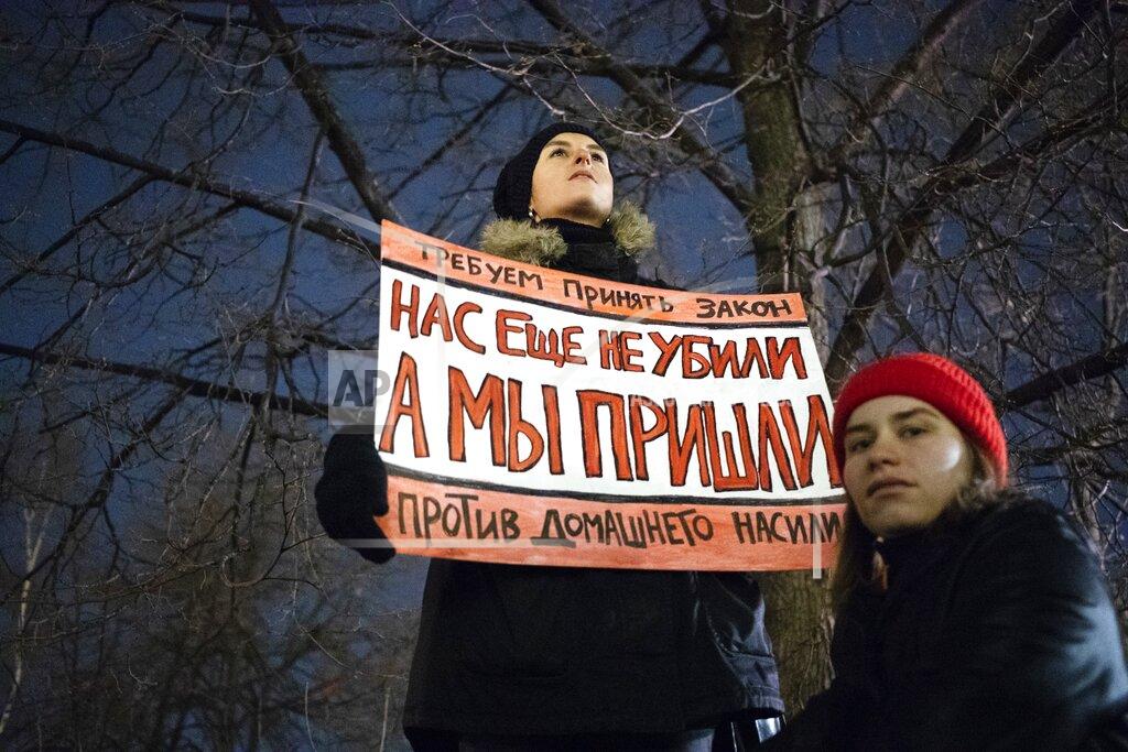 Pavel Golovkin FILE - In this Nov. 25, 2019, file photo, a woman holds a banner reading, "We demand the adoption of a law against domestic violence. We have not been killed yet, but we're close," as she attends a rally in Moscow, Russia. Few reliable official statistics are kept on violence against women in Russia, but it is clearly a national problem. Police routinely turn a blind eye to domestic abuse, and restraining orders don't exist, leaving victims without a key protection. (AP Photo/Pavel Golovkin, File)