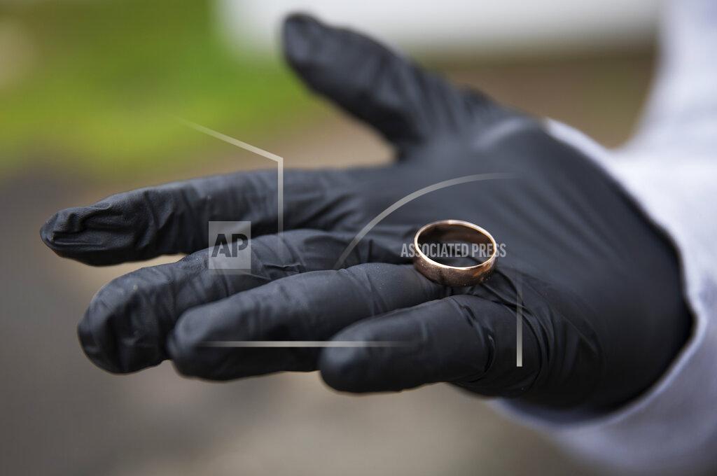 David Goldman Michael Tokar holds the ring of his father, David Tokar, after it was returned to him before his burial at Mount Richmond Cemetery in the Staten Island borough of New York, Wednesday April 8, 2020. "My father wore this ring all his life and I want to keep it for me. It's the best memory. It's like part of my father." (AP Photo/David Goldman)