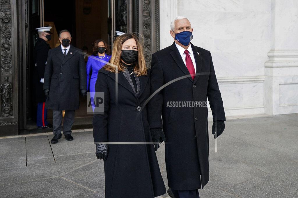 Melina Mara Former Vice President Mike Pence and his wife, Karen Pence, followed by Vice President Kamala Harris and her husband Doug Emhoff, walk out of the Capitol after the inauguration of President Joe Biden Wednesday, Jan. 20, 2021, at the U.S. Capitol in Washington. (Melina Mara/The Washington Post via AP, Pool)