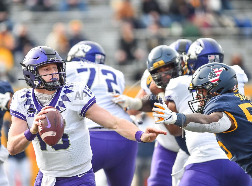 William Wotring TCU quarterback Max Duggan (15) scrambles to avoid the sack by West Virginia defensive lineman Dante Stills (55) during the second half of an NCAA college football game on Saturday, Nov. 14, 2020, in Morgantown, W.Va. (William Wotring/The Dominion-Post via AP)