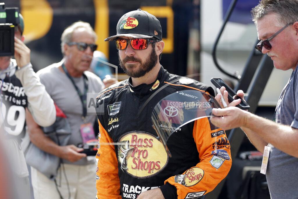 Gerry Broome Martin Truex Jr. walks past fans during practice for Sunday's NASCAR Cup Series auto race at Charlotte Motor Speedway in Concord, N.C., Saturday, Sept. 28, 2019. (AP Photo/Gerry Broome)