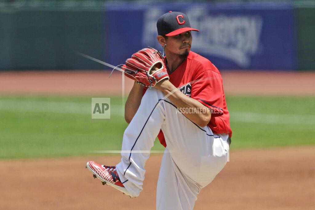 Tony Dejak Cleveland Indians starting pitcher Carlos Carrasco winds up in the first inning in a baseball game against the Kansas City Royals, Sunday, July 26, 2020, in Cleveland. (AP Photo/Tony Dejak)