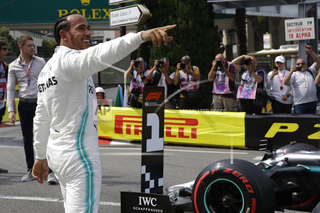 Luca Bruno Mercedes driver Lewis Hamilton of Britain celebrates after he clocked the fastest time during the qualifying session at the Monaco racetrack, in Monaco, Saturday, May 25, 2019. The Formula one race will be held on Sunday. (AP Photo/Luca Bruno)