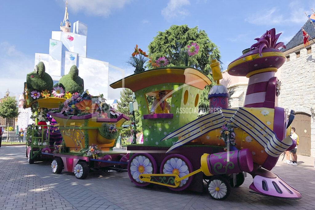 Catherine Gaschka A float rides in Disneyland Paris in Marne-la-Vallée, east of Paris, Thursday, June 17, 2021. France's tourism sector takes a further step toward post-pandemic recovery with the reopening of Disneyland Paris, two weeks after the country formally welcomed back vaccinated foreign visitors. (AP Photo/Catherine Gaschka)