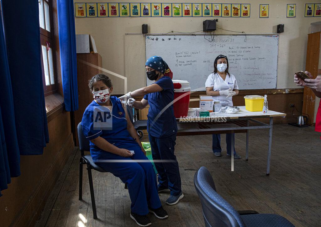 Esteban Felix FILE - In this Monday, Feb. 15, 2021, file photo, a teacher receives a shot of the CoronaVac vaccine for COVID-19, by China's Sinovac Biotech, at Salvador Sanfuentes public school during the start of the vaccinations for educators in Santiago, Chile. It wasn’t until Sinovac swooped in with 4 million doses in late January that Chile began inoculating its population of 19 million with impressive speed. (AP Photo/Esteban Felix)