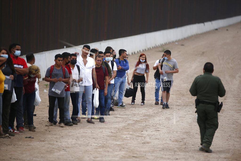Dario Lopez-Mills A Border Patrol agent instructs migrants who had crossed the Rio Grande river into the United States in Eagle Pass, Texas, Friday, May 20, 2022. The Eagle Pass area has become increasingly a popular crossing corridor for migrants, especially those from outside Mexico and Central America, under Title 42 authority, which expels migrants without a chance to seek asylum on grounds of preventing the spread of COVID-19. A judge was expected to rule on a bid by Louisiana and 23 other states to keep Title 42 in effect before the Biden administration was to end it Monday. (AP Photo/Dario Lopez-Mills)