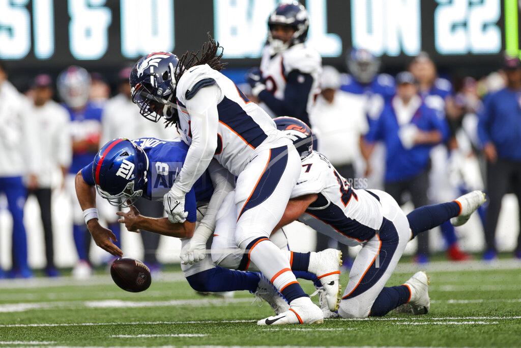 New York Giants quarterback Daniel Jones (8) fumbles the ball as Denver Broncos' A.J. Johnson (45) tackles him during the second half of an NFL football game Sunday, Sept. 12, 2021, in East Rutherford, N.J. The Broncos recovered the ball on the play. The Broncos won 27-13. (AP Photo/Adam Hunger)