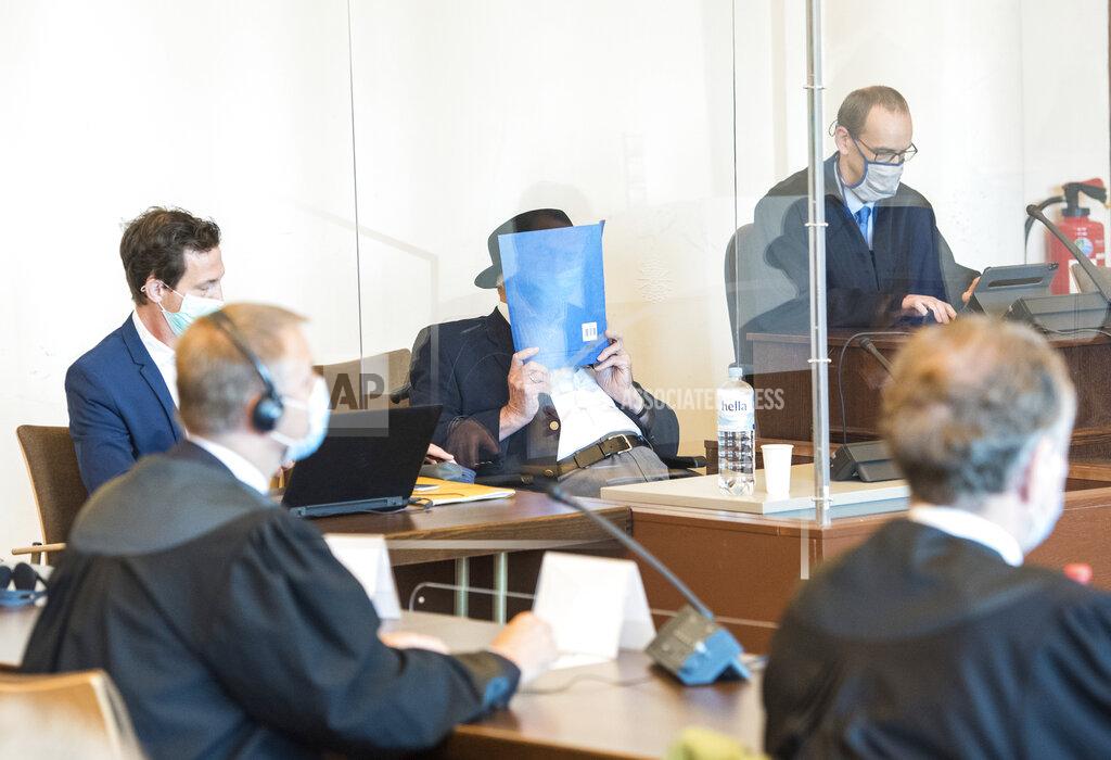 Daniel Bockwoldt A 93-year-old former SS guard of the Stutthof concentration camp near Danzig in Poland sits in a courtroom behind a Plexiglas pane in the regional court in Hamburg, Germany, Thursday, July 23, 2020. Next to him sits his lawyer Stefan Waterkamp, right. The Regional Court of Hamburg sentenced the former guard to two years juvenile sentence on probation. The juvenile court found him guilty of aiding and abetting murder in 5232 cases and of aiding and abetting attempted murder. (Daniel Bockwoldt/dpa via AP)